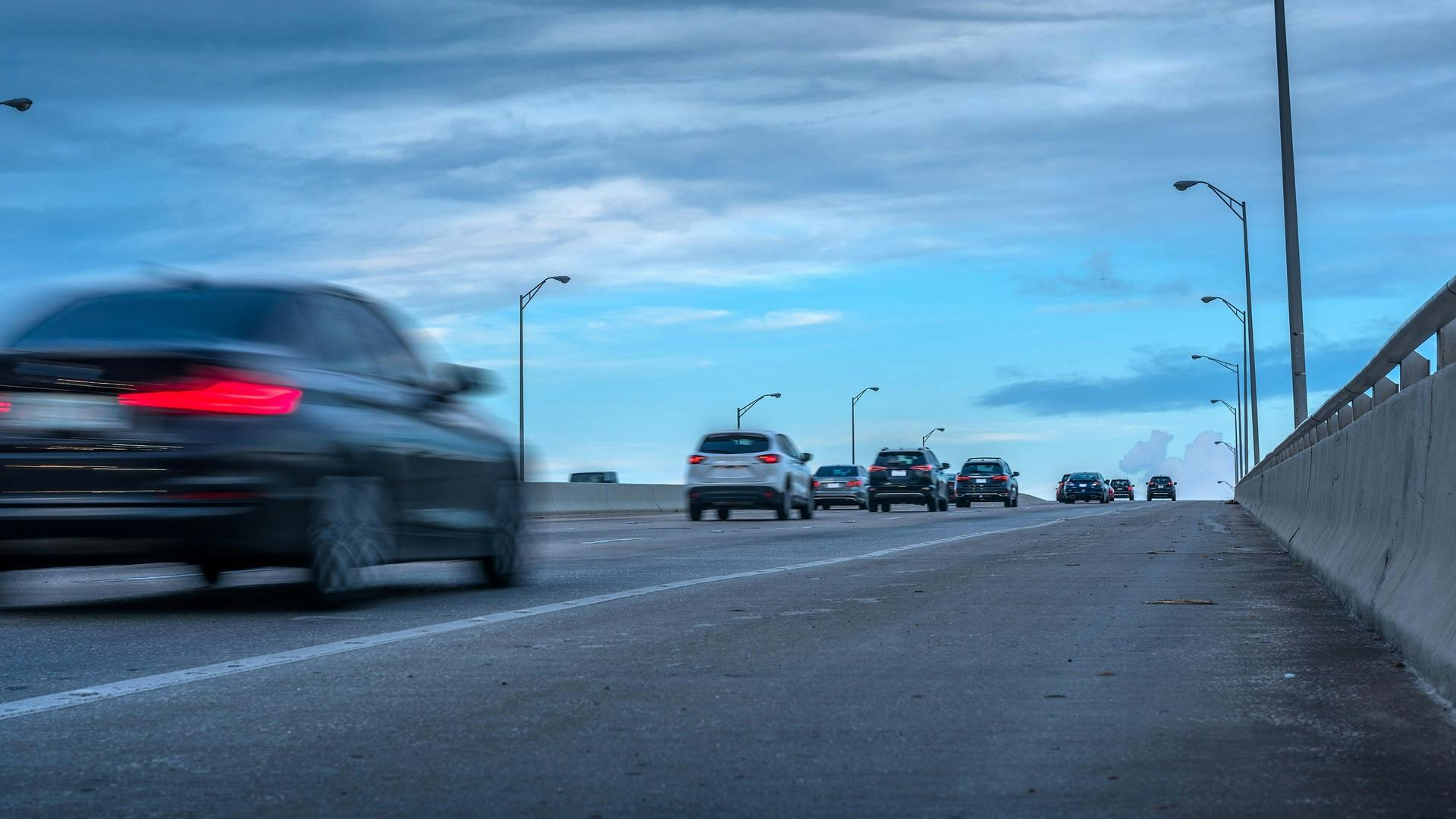 Cars driving down a two-lane highway road