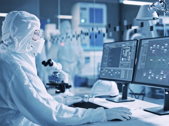 Person working in semiconductor lab.