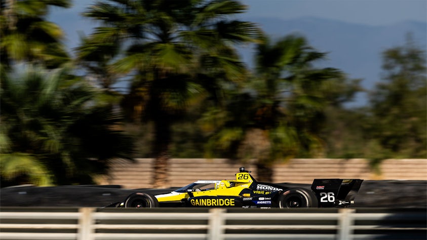 A car running at a high speed on a race track.