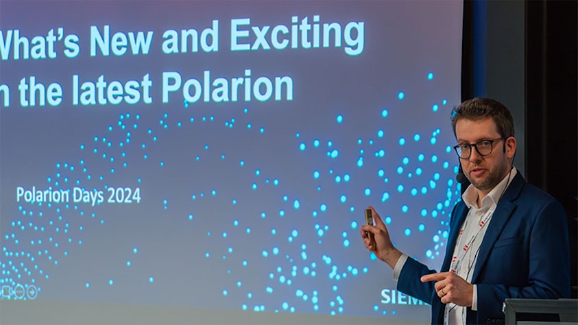 At the Siemens Realize LIVE digital transformation conference, a speaker presents the latest Polarion information.