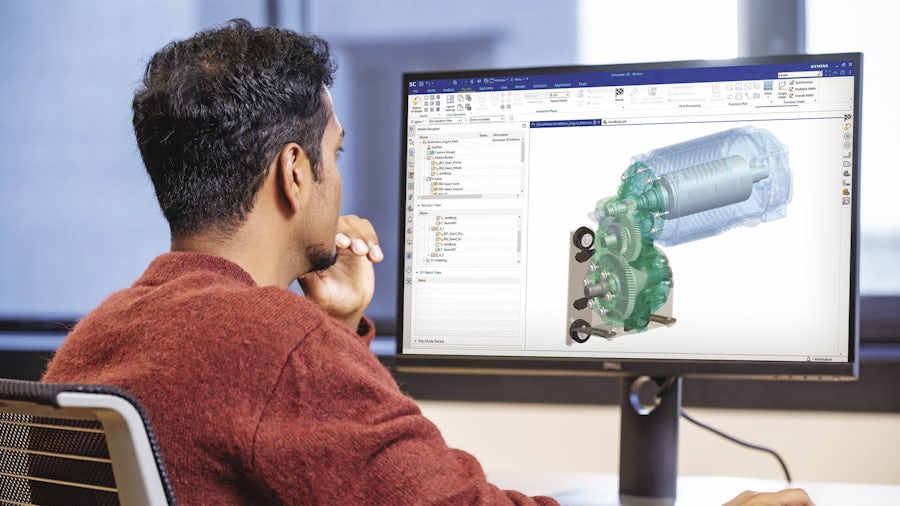 Engineer sitting at a computer screen running a multibody dynamics simulation of an electric vehicle powertrain.