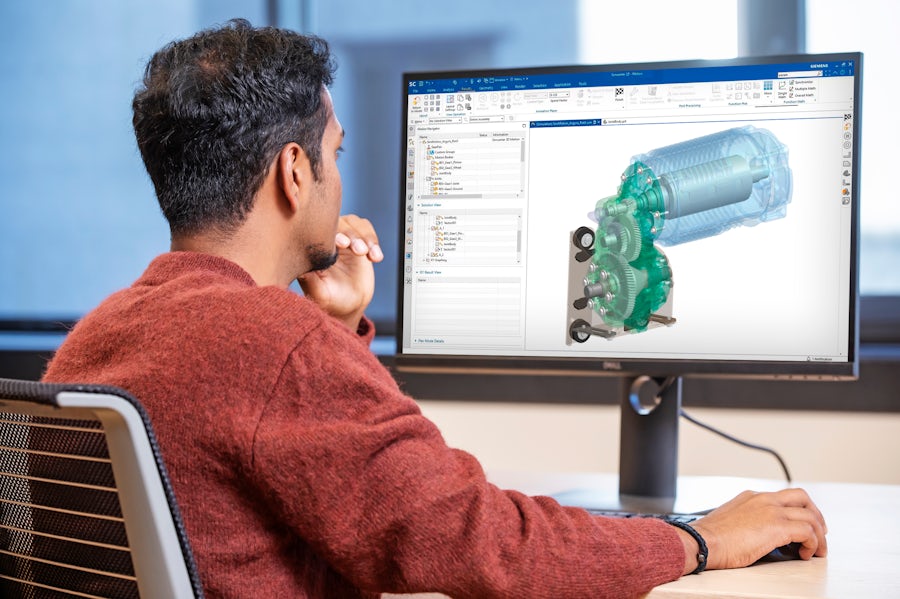 Engineer sitting at a computer screen running a multibody dynamics simulation of an electric vehicle powertrain.