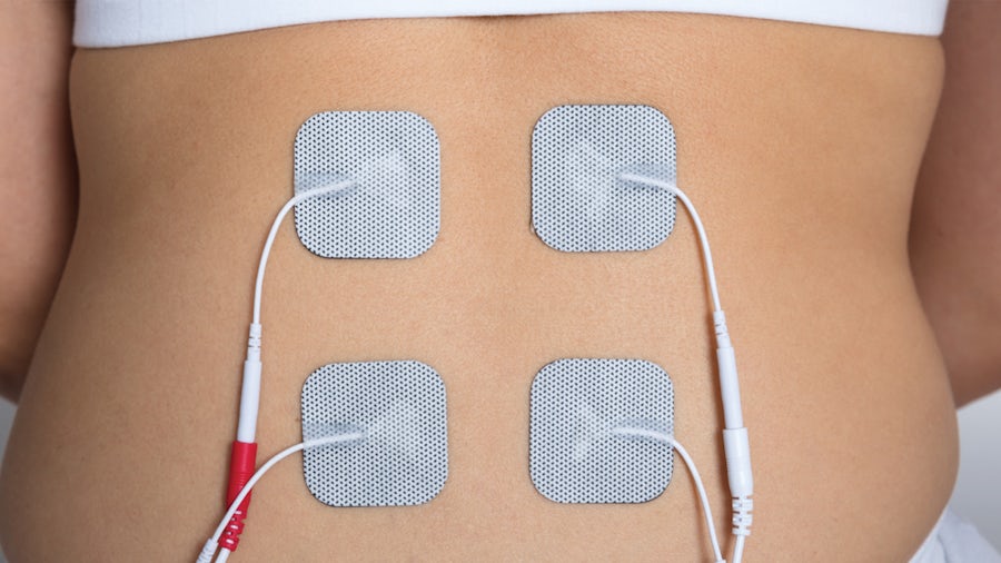A person's back with device on it