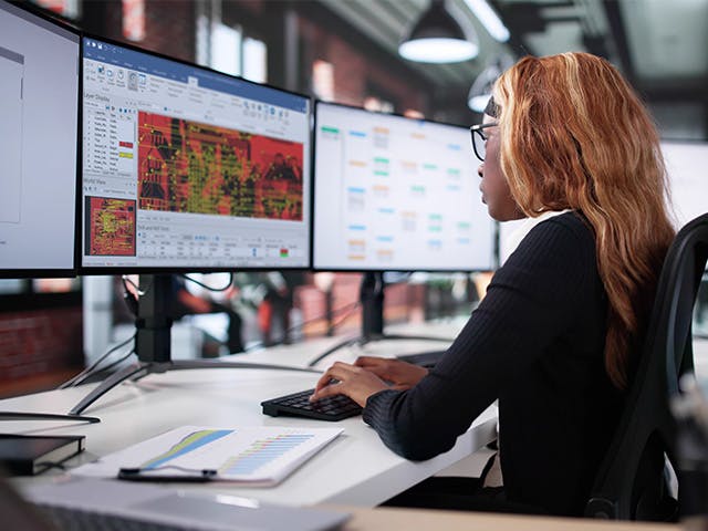 An engineer working on CAM350 software.