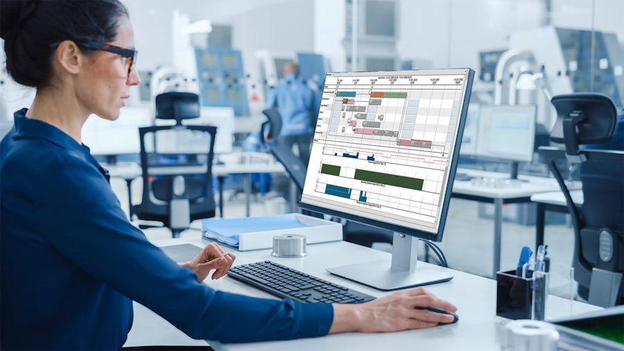An engineer uses advanced planning and scheduling software to optimize manufacturing operations.