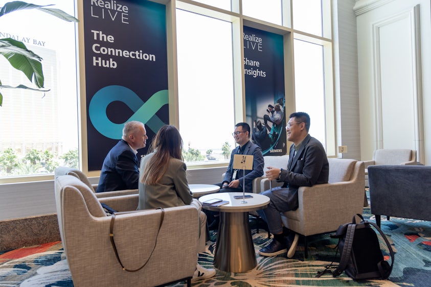 Four Realize LIVE attendees networking in the Connections Hub at Realize LIVE 2023
