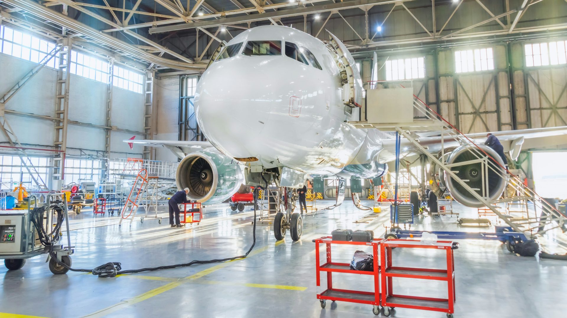 A commercial airplane sits in a hangar. 