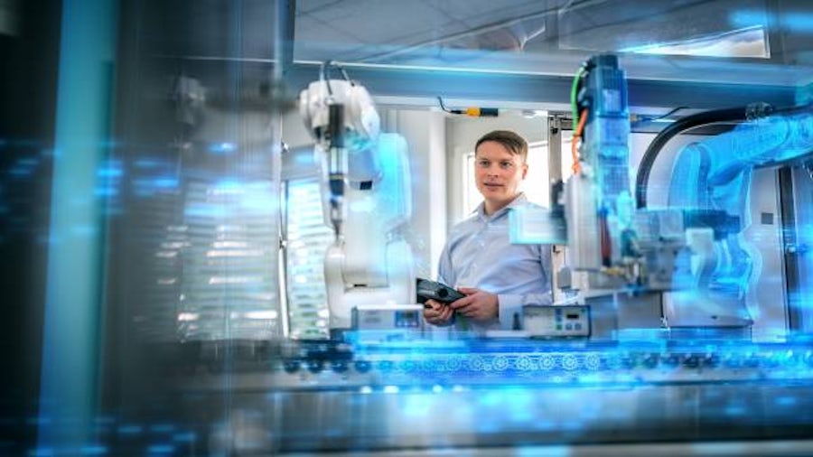 A manager watching a factory machine with digital twin