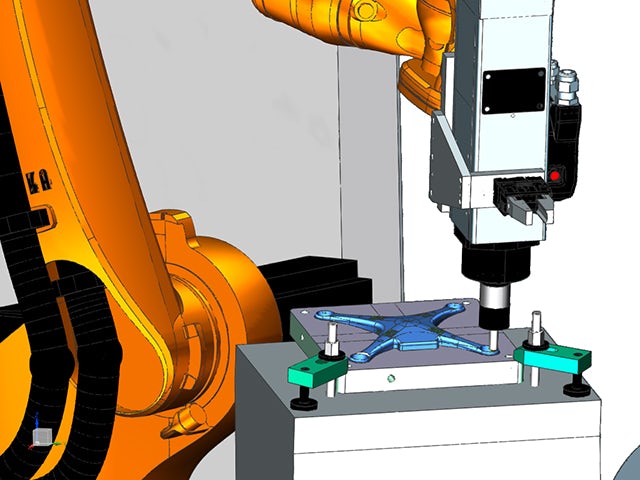 Robot de fábrica que mecaniza una pieza.