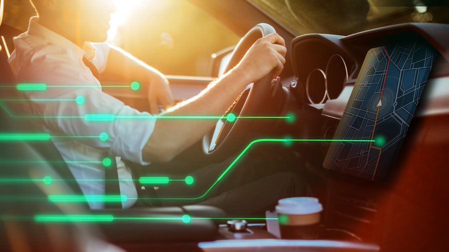 Interior view of a man driving an electric vehicle.