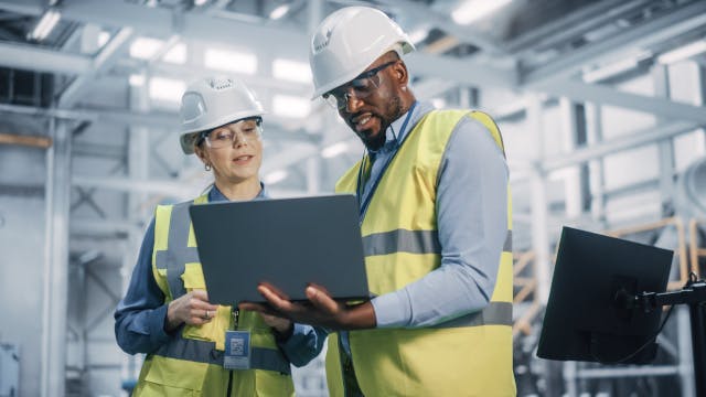 Two people working on a computer.