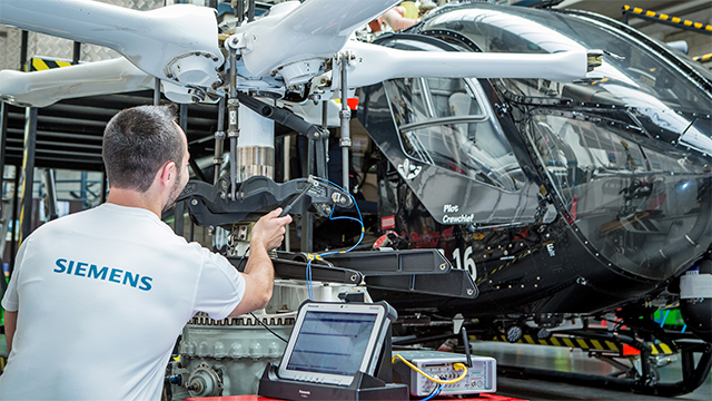 Engineer testing aircraft vibrations on the ground with Simcenter solution.