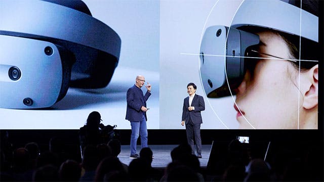 Joe Bohman, Siemens, and a Sony representative are presenting on stage at Realize LIVE.