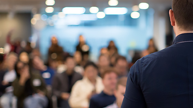 Man presenting learning and development to group at Siemens office location 