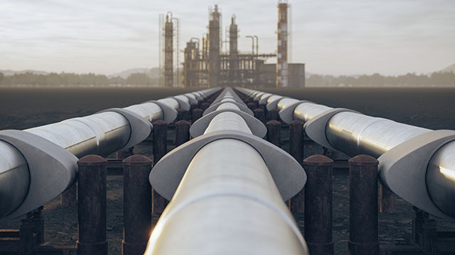 Closeup of pipelines leading to a refinery.