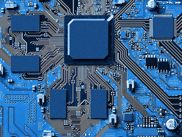 Up close image of a blue electronic circuit board.