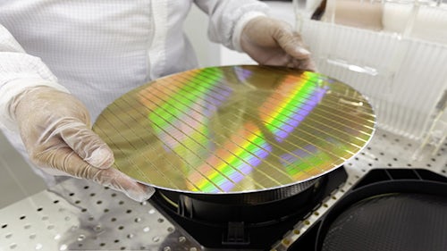 Image of person holding a silicon wafer.