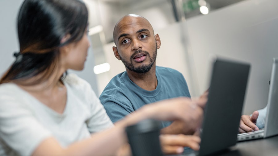 man and woman looking at a computer screen