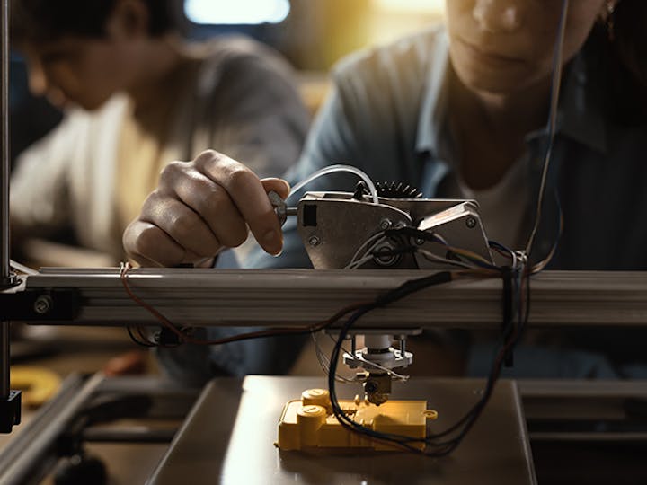 Student working on a 3D printer.