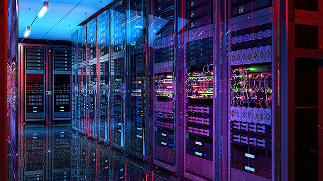 Row of data center server racks in a dimly lit room.