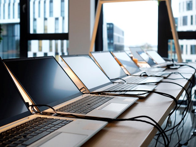 Multiple computers aligned in a row.