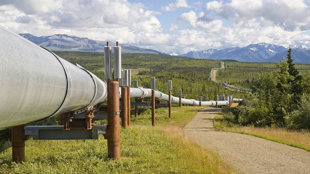 A pipeline running through an open field.