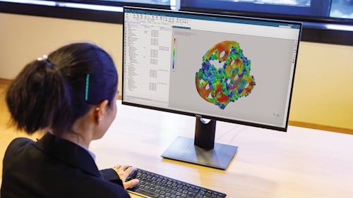An engineer performing generative engineering using Simcenter 3D on her computer.