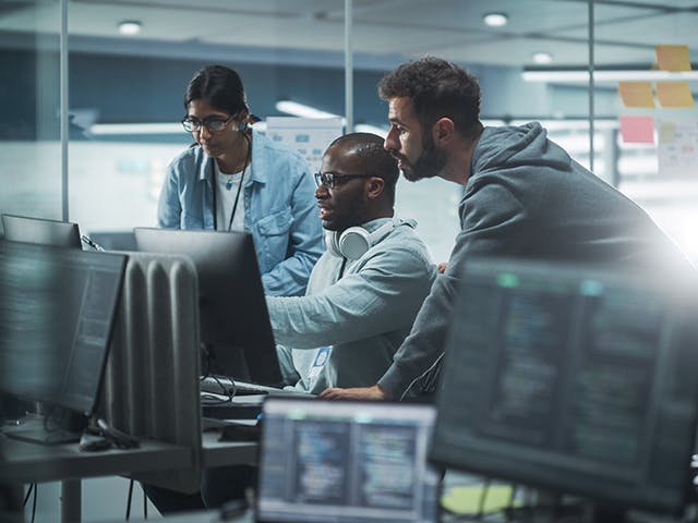 Engineers from different disciplines sharing MCAD, ECAD, and related information on a computer.