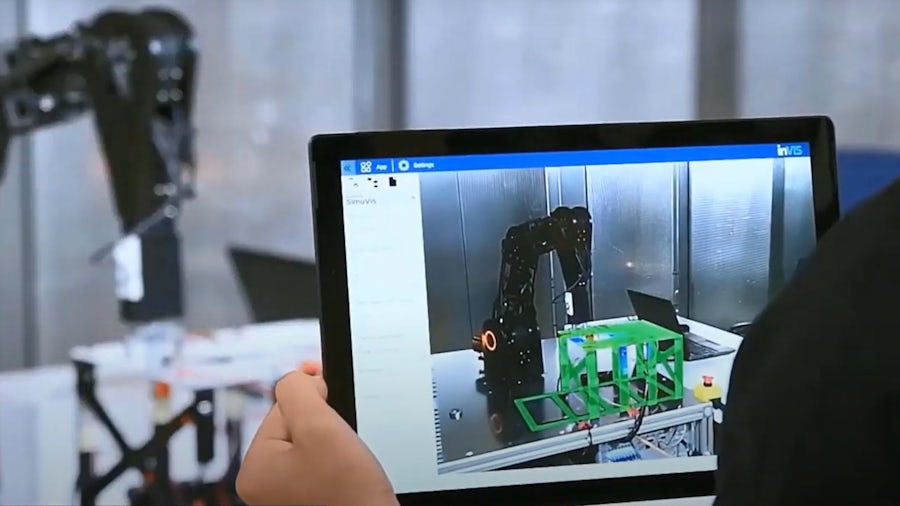 Engineer visualizing stress on a structure in real-time as robot arm presses on it.