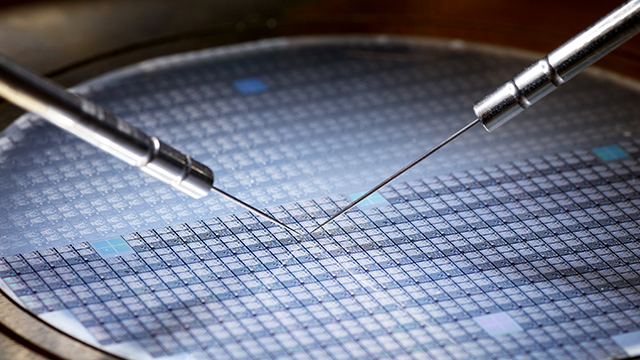 Test probes touching a wafer.