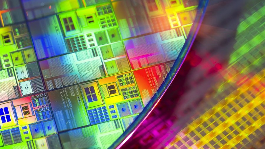 picture of two silicon wafers overlapping and showing off their iridescence in the rainbow color spectrum 