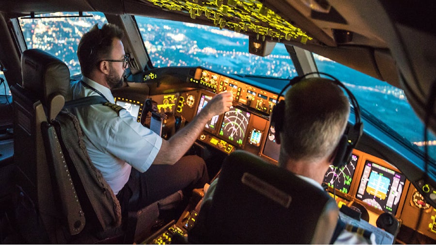 two pilots in cockpit of airplane