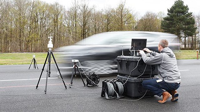 An engineer is testing pass-by noise level limits on a car running on the road.