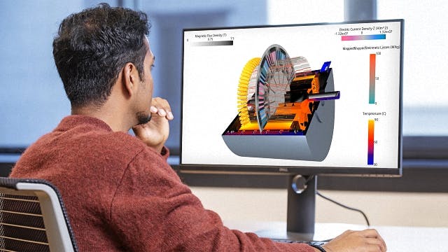 An engineer looks at the cooling simulation of an e-machine on a computer with Simcenter software.