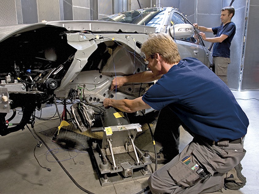 The engineering team performing a modal analysis on a car structure.