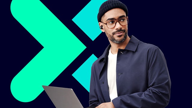 A man looks off in the distance while holding a laptop, with the Xcelerator logo behind him