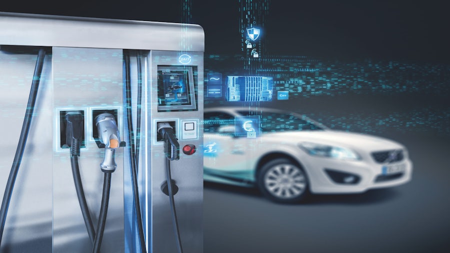 an electric vehicle approaching a smart charging station with a graphic representation of the vehicle's software communicating with the smart station. 