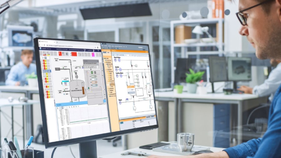 A man engaged with his computer in a professional office space.