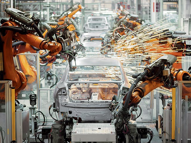 Industrial robots perform automated welding operations in car manufacture. KineoWorks robotics simulation software can be used to compute collision-free robot motion.