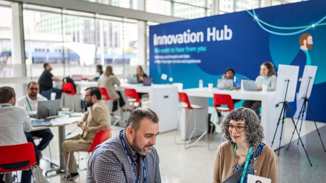 2 individuals sitting at the Innovation Hub.