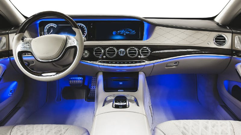 Rendered design of the automotive interior of a connected car featuring an in-vehicle networking display in the dashboard.