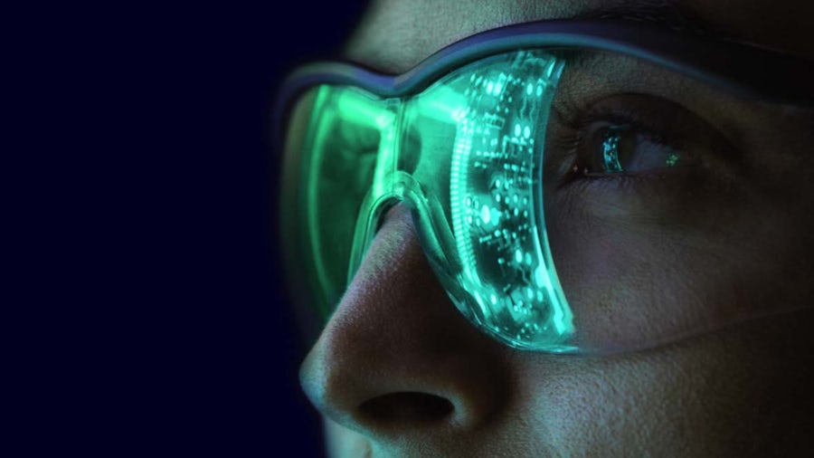 Eine Frau mit einer grünen Brille mit leuchtenden Lichtern