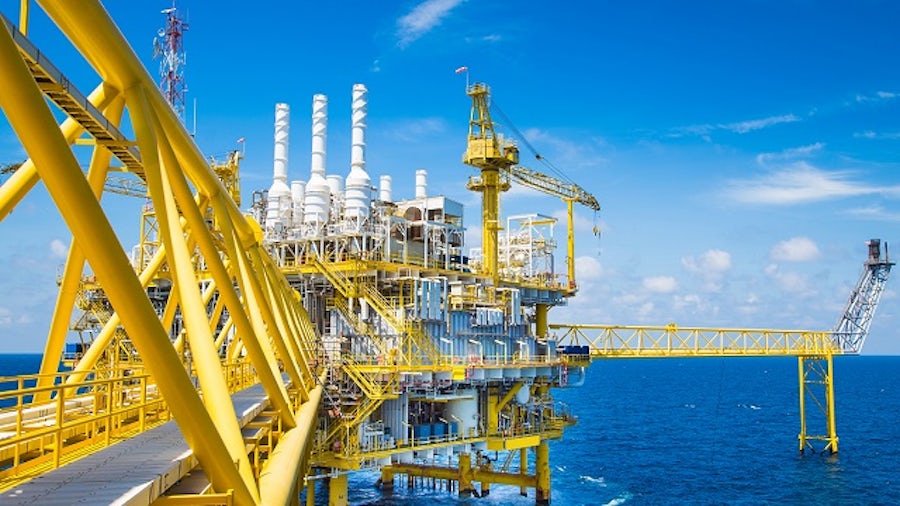 Yellow colored offshore oil refinery in the ocean