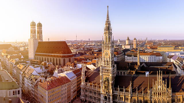 The skyline of Munich, Germany, including the neo-gothic Neues Rathaus (town hall) in the foreground and the Münchner Dom (Munich Cathedral).