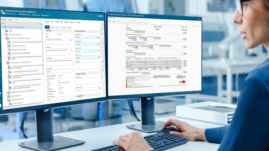 Worker using Teamcenter Quality software to manage audit and assessment process. 