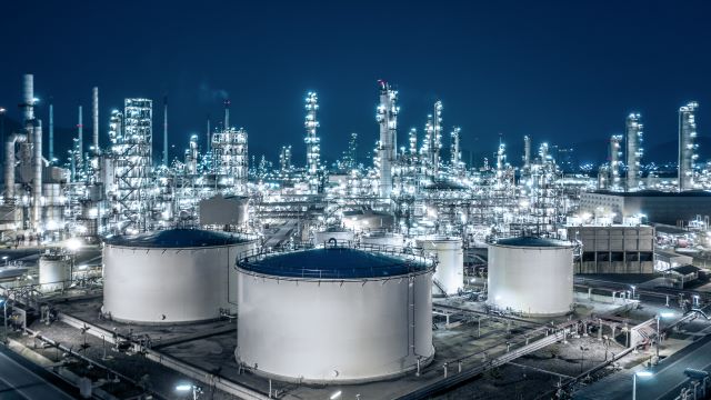 Lights shine at night at an oil refinery.
