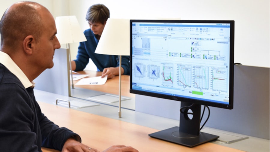 An engineer using Simcenter Testlab software for fatigue and load data analysis.