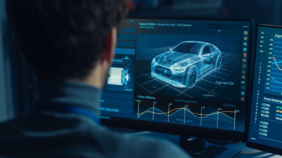 Man reviewing virtual car on computer screen