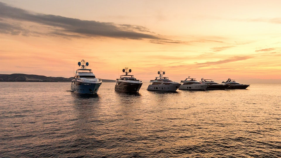 A row of yachts parked in the water.