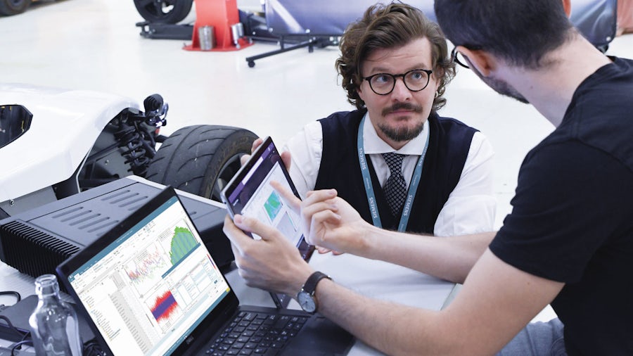 Engineers reviewing prior NVH test data stored in a centrally located database.